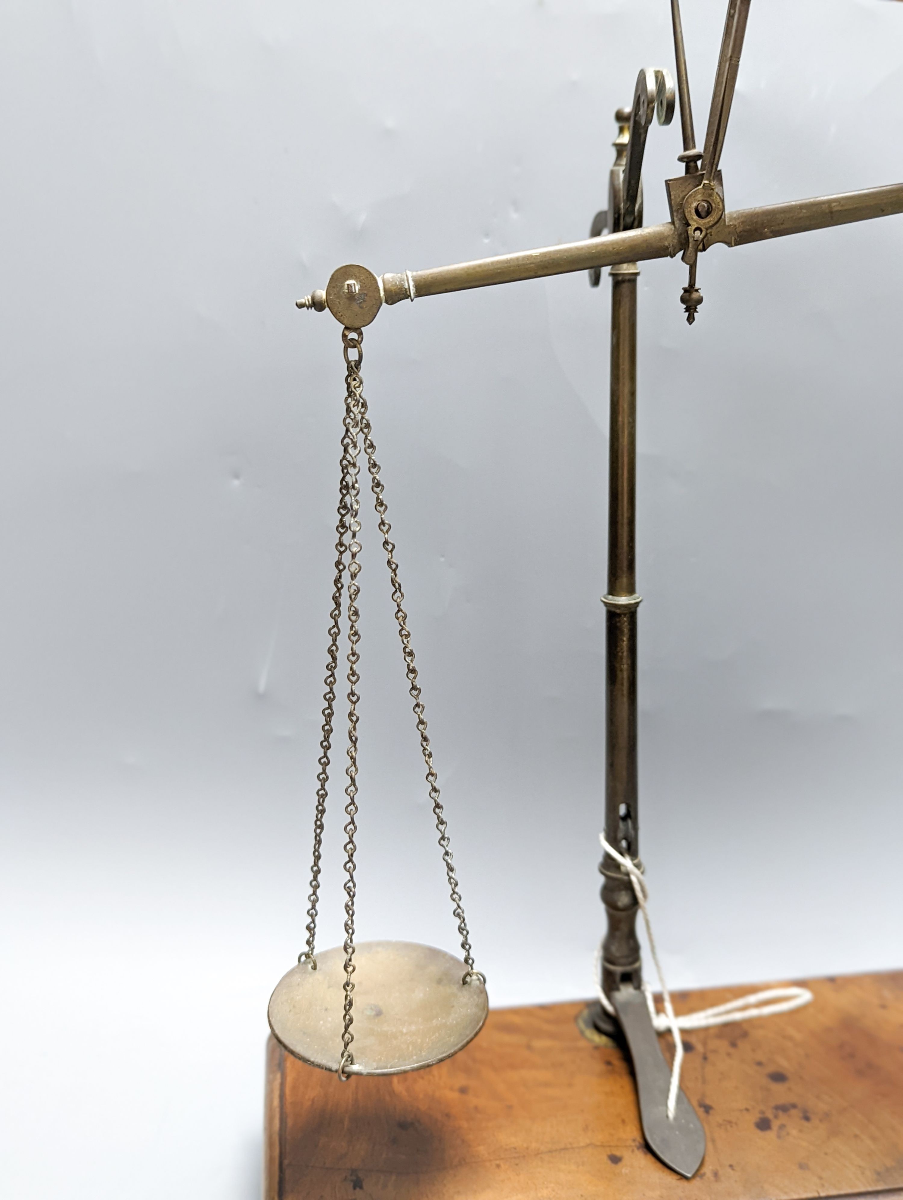 A Victorian cased weighing scale, two papier mache wine coasters and surveyor's measure.